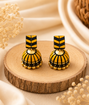Amber Stack handmade terracotta jhumki earrings displaying a unique layered geometric design hand-painted in warm amber and gold.