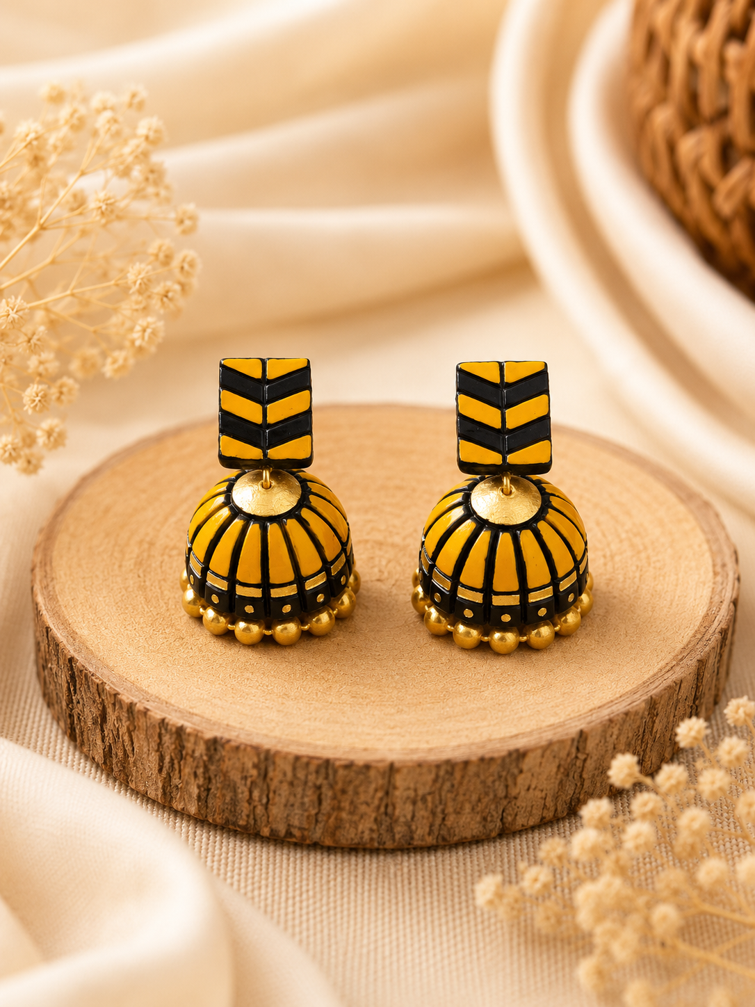 Amber Stack handmade terracotta jhumki earrings displaying a unique layered geometric design hand-painted in warm amber and gold.