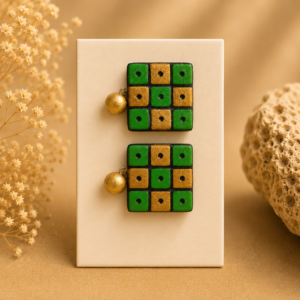 Handcrafted forest green terracotta jewellery set featuring geometric grid patterns with matching necklace and earrings.