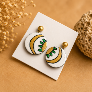 Handcrafted ivory-toned terracotta jewellery set featuring palm-inspired patterns with matching necklace and earrings.