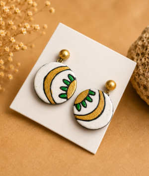 Handcrafted ivory-toned terracotta jewellery set featuring palm-inspired patterns with matching necklace and earrings.