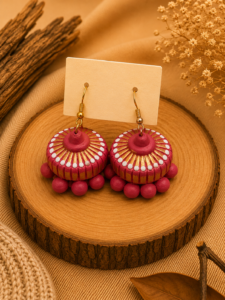 Pink Royale handmade terracotta hanging jhumka earrings showcasing a regal, hand-painted tiered clay design in rich pink and metallic gold.