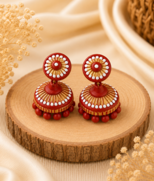 Ruby Bloom handmade terracotta jewellery set featuring a hand-painted floral clay pendant and matching earrings in ruby red tones.