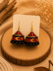 Rustic Heritage handmade terracotta hanging jhumka earrings displaying a hand-painted antique tiered clay design in traditional brick red, brown, and gold.