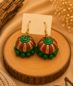 Sunset Carnival handmade terracotta hanging jhumka earrings featuring hand-painted traditional tiered clay designs in festive orange, red, and gold.