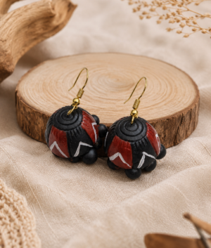 Pair of Tribal Twilight handmade terracotta hanging jhumka earrings featuring long tiered clay designs hand-painted in black, gray, and gold